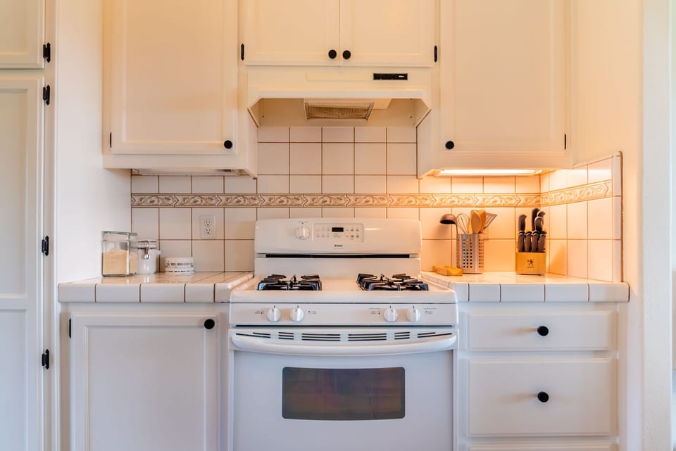 White cabinets and a gas range keep this kitchen efficient.