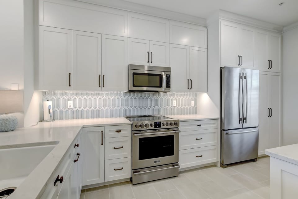 Brand New Kitchen With Quartz Countertops, Stylish Tiled Backsplash, Stainless Steel Appliances and Counter Seating for 2