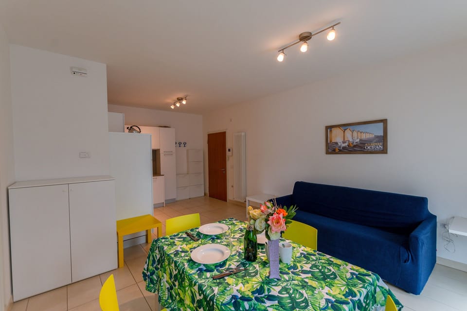 The living room with coffee table, dinner table and view of the kitchen