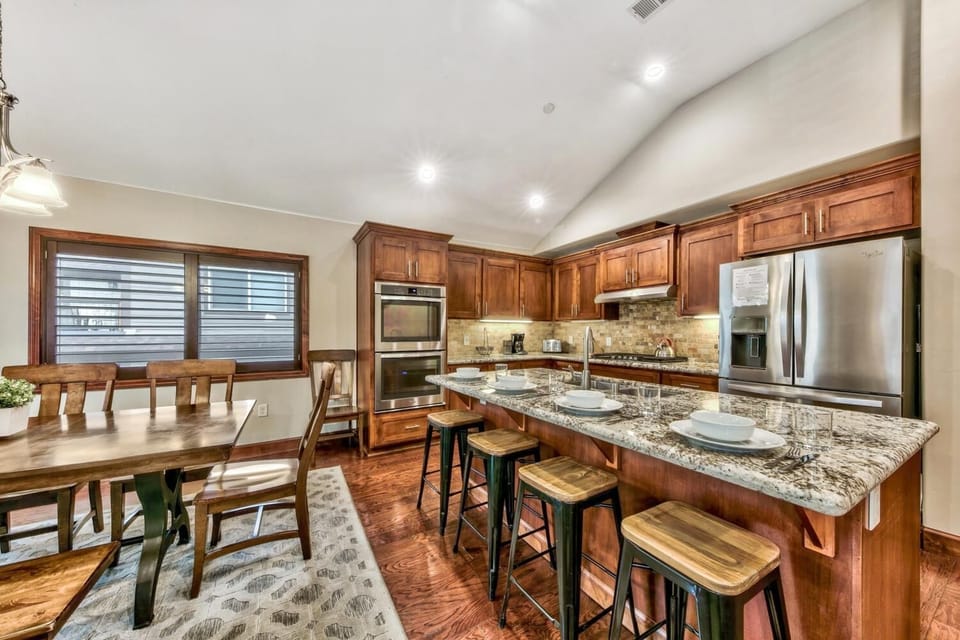 Your gourmet kitchen features granite countertops, stainless steel appliances, and a spacious island perfect for cooking memorable meals together.