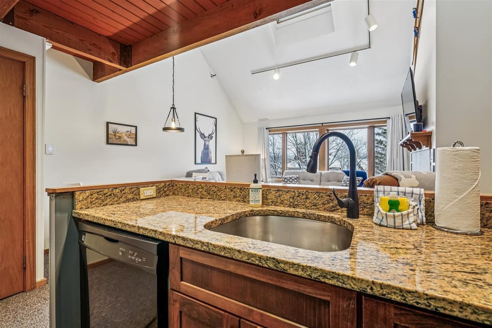 Granite counters, a deep sink, and generous prep space make this kitchen both practical and easy to use for full meals or quick breakfasts.
