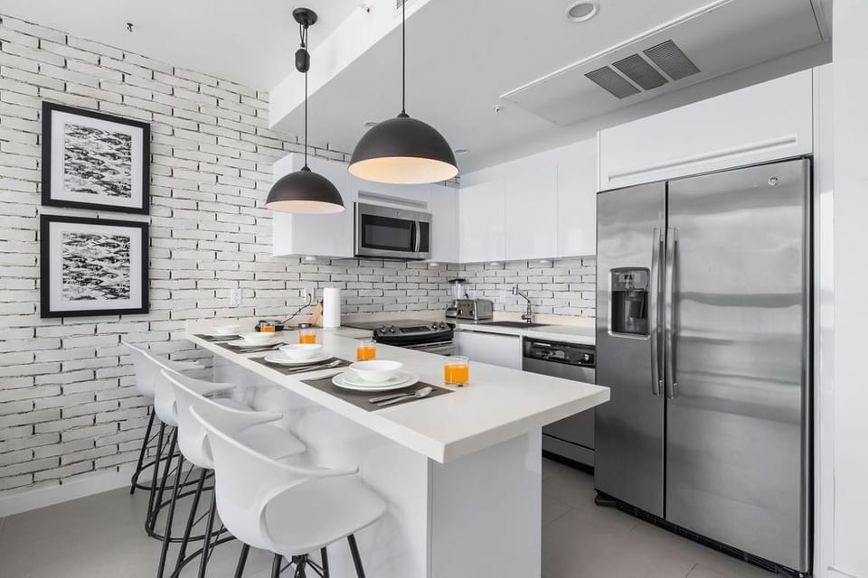 Your sleek kitchen features modern appliances, a spacious island for meals, and contemporary design with clean lines that make cooking and dining effortless.