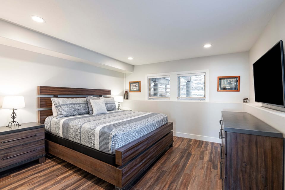 Main Level - Bedroom 3 with King Bed, 55" TV, and En Suite Bathroom