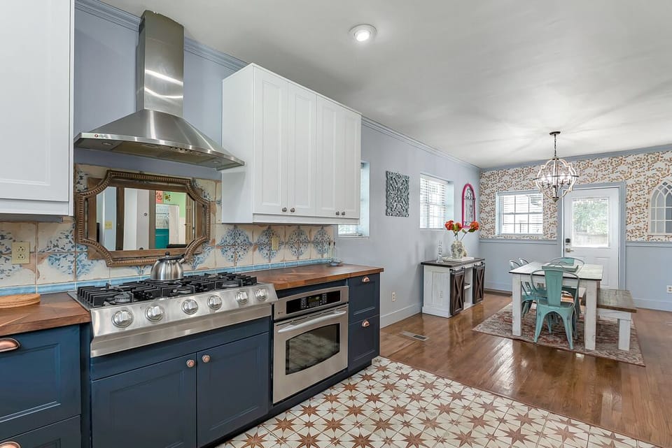Full kitchen with stylish tile floors and space to cook and gather.