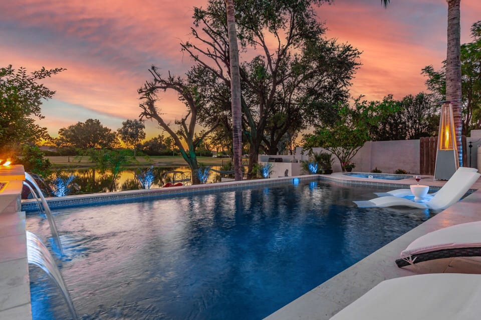 Large heated pool with waterfalls and fire bowls