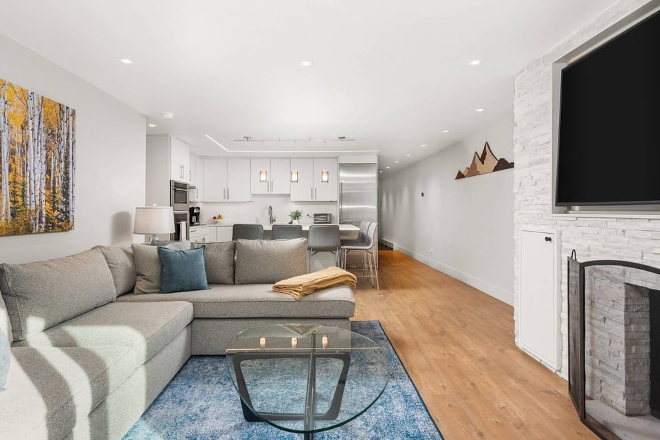 This luxury garden level unit has been designed to create a bright and welcoming space with a wood fireplace and flat screen TV.