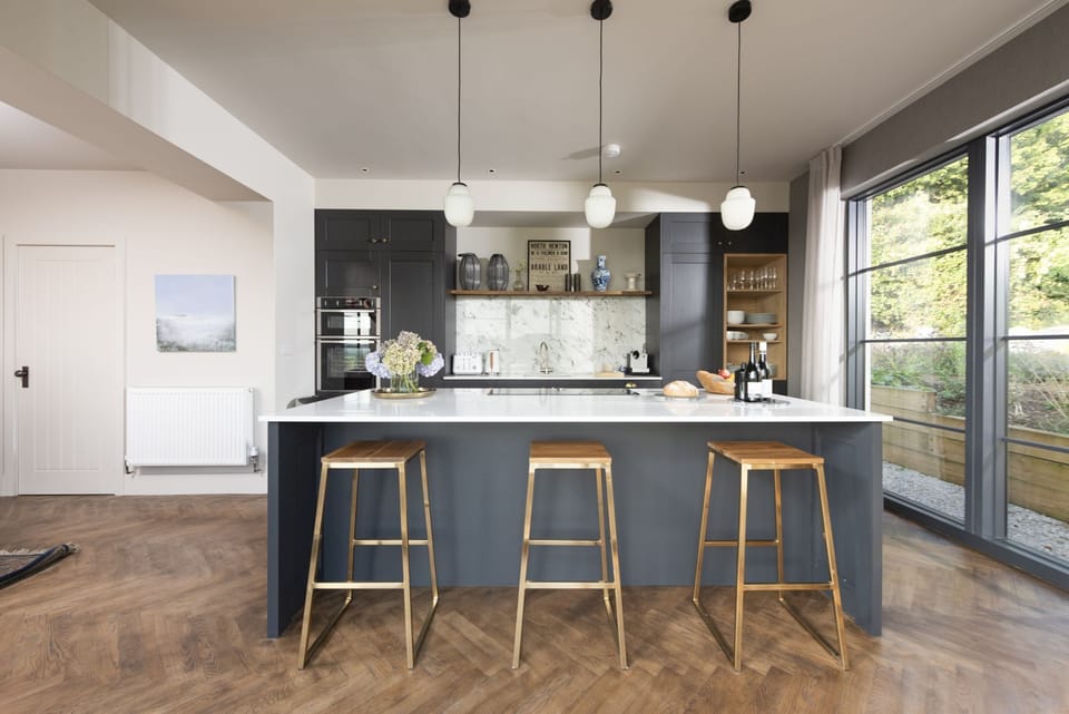 The kitchen with a hob, stovetop and view to the garden - Decoy Farm
