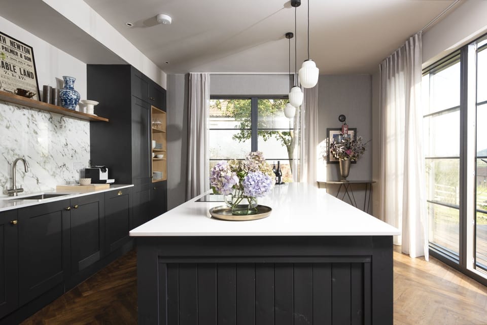 The kitchen with a hob, stovetop and view to the garden - Decoy Farm