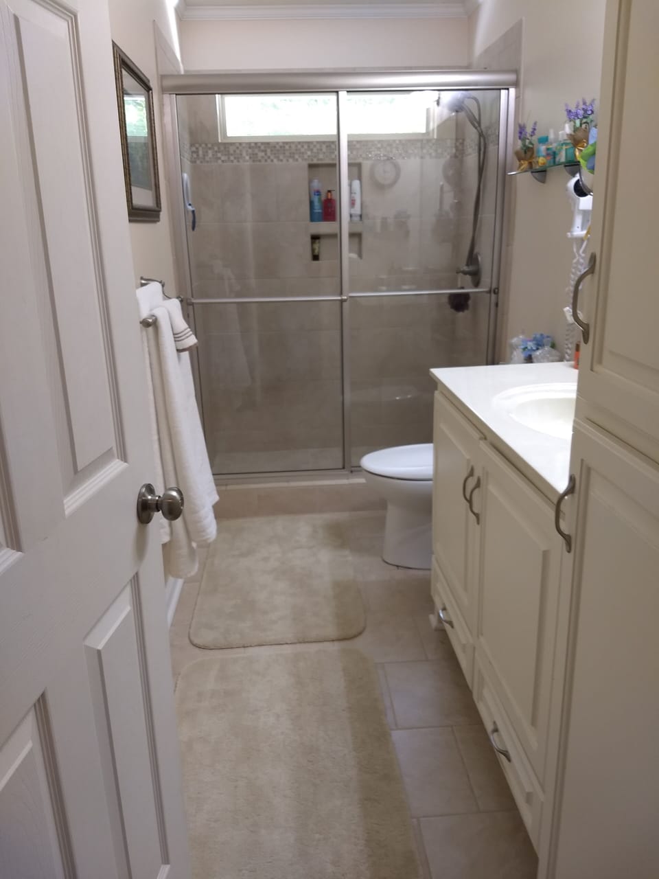 Bathroom has walk-in shower, hair dryer, bath sheet towels and amenities.