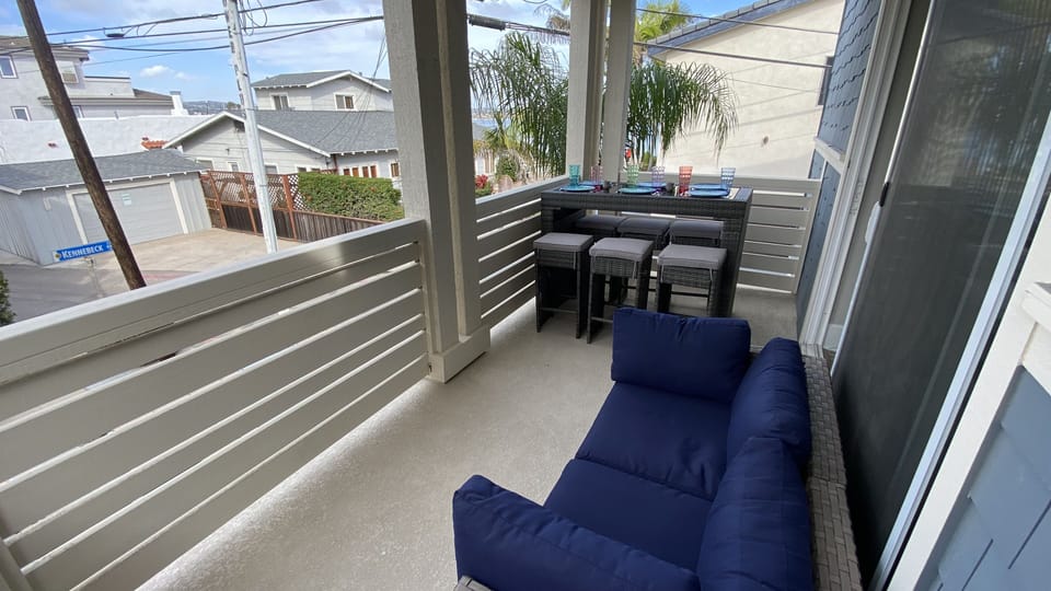 2nd floor deck with Mission Bay water view, dining for 6 and love seat.