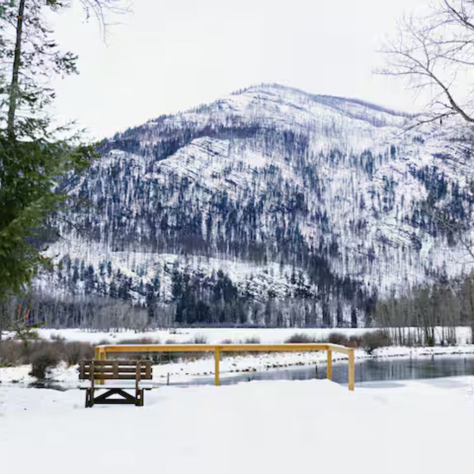 Quiet winter patio—soak in snowy mountains mirrored on the lake.