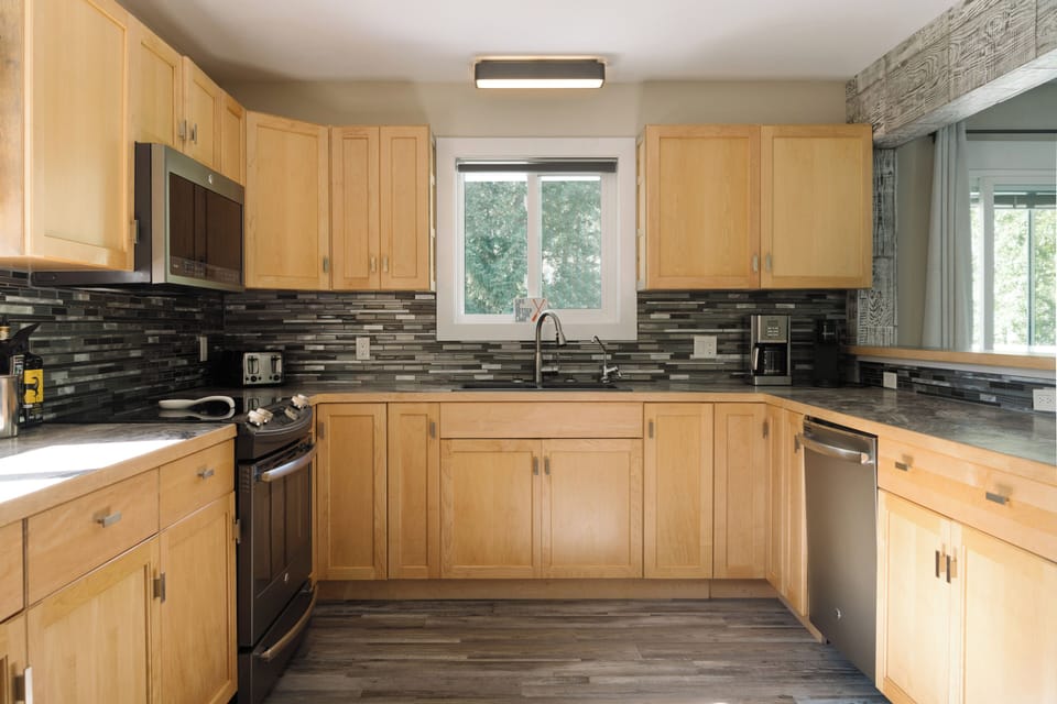 Bright kitchen with stainless appliances and space to cook together.