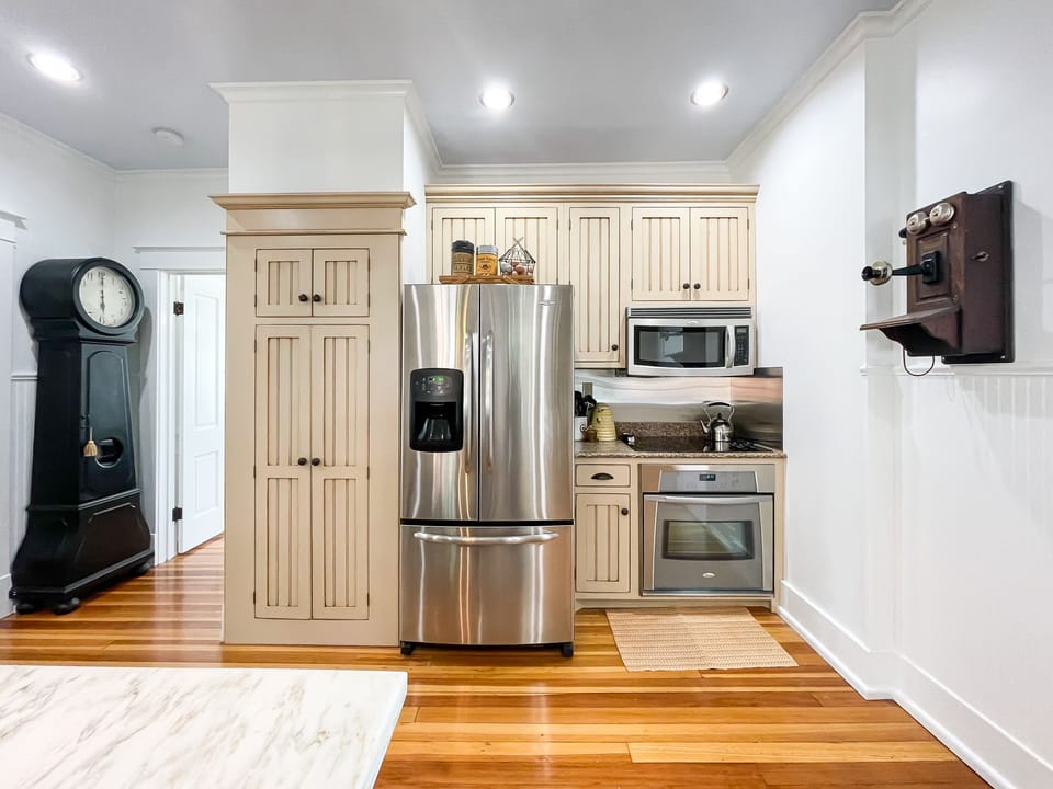 The beautifully detailed full kitchen has everything you need to make your own meals, including place settings, pots and pans, wine glasses, and a regular coffee maker or a Keurig at the Bee's Knees (Beekeeper's Cottage).