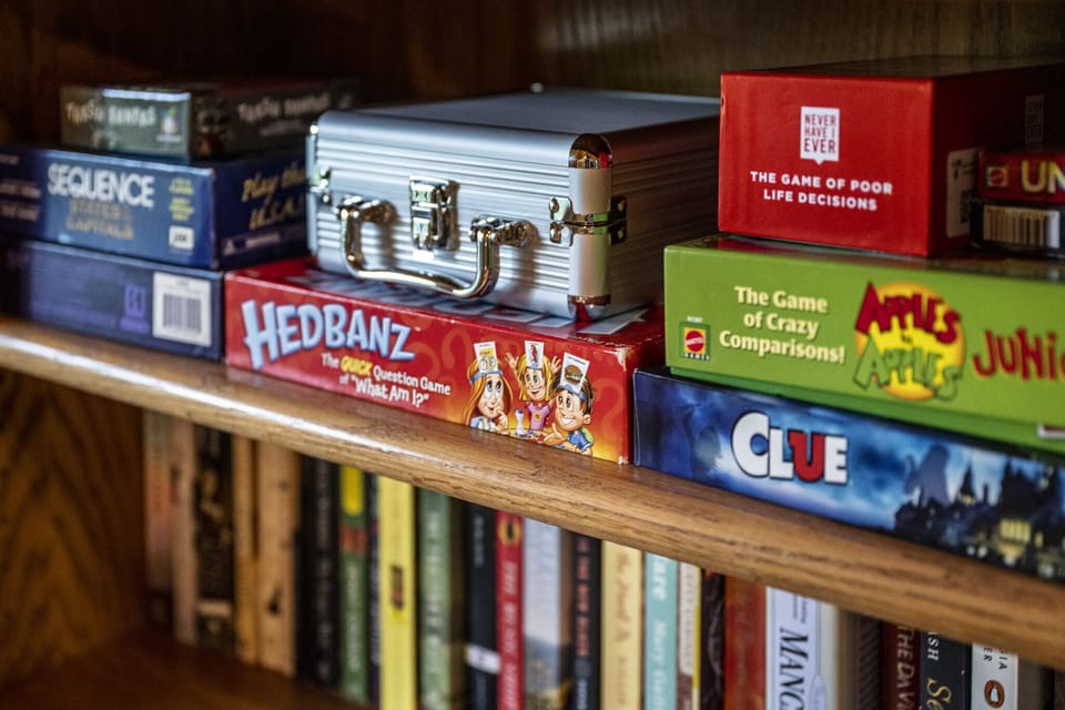 Many games and books are stocked in the loft bookshelf