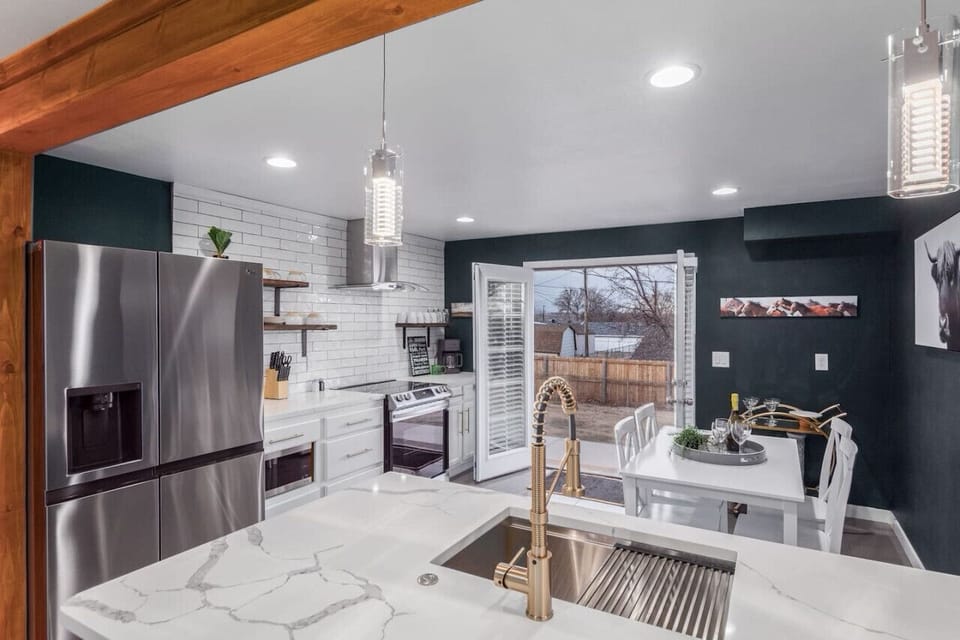 A sleek updated kitchen with walkout patio to the hot tub/ private yard.