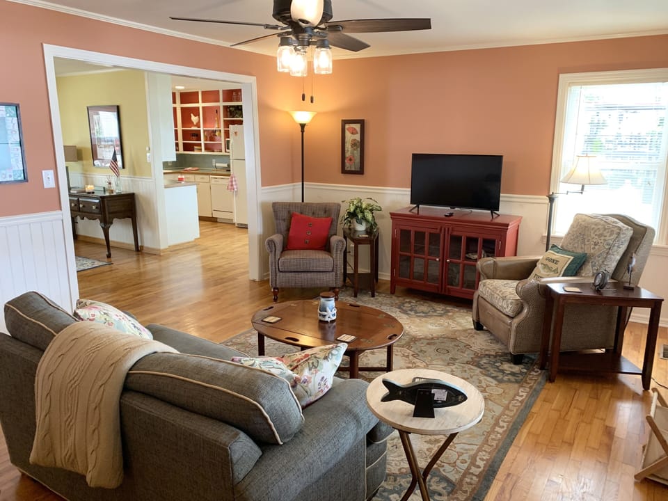 Living Room with comfy seating areas and a Smart TV, ready for streaming.