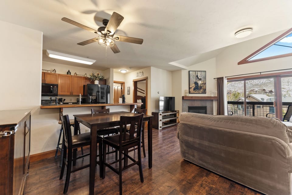 Relax in your open-concept living space where comfortable seating, dining table, and full kitchen create the perfect home base for your getaway.