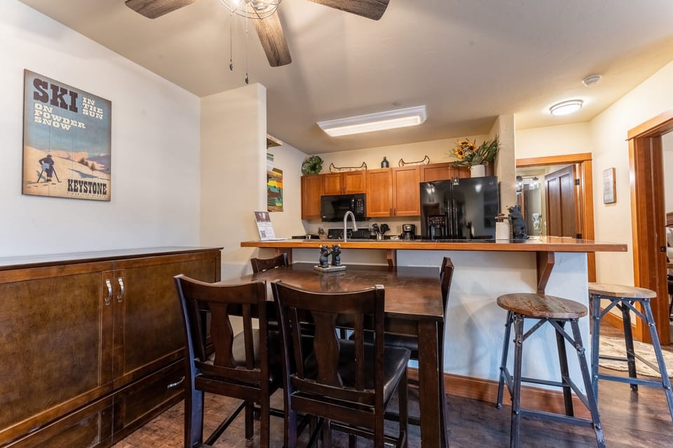 Your fully equipped kitchen opens to a breakfast bar where you can enjoy morning coffee with ski resort charm and mountain memories.
