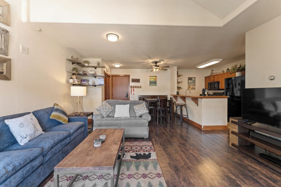 Relax in your spacious living room with comfortable seating, then cook meals in the fully-equipped kitchen—perfect for unwinding after adventures.