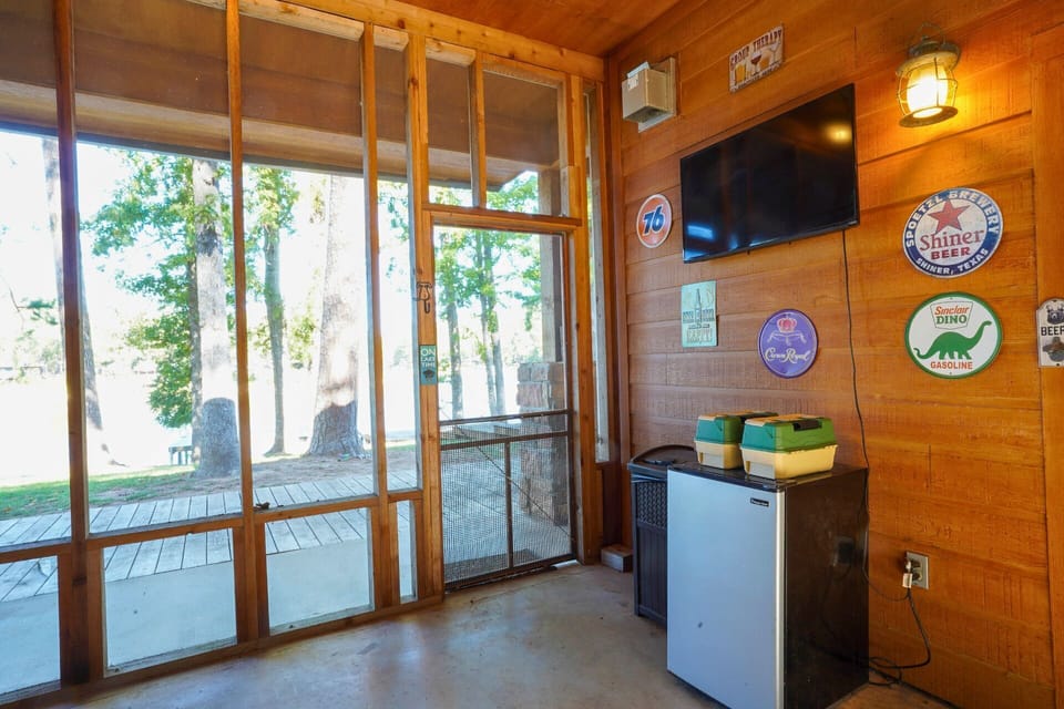 Screened-in patio with TV — relax indoors while enjoying lake views.