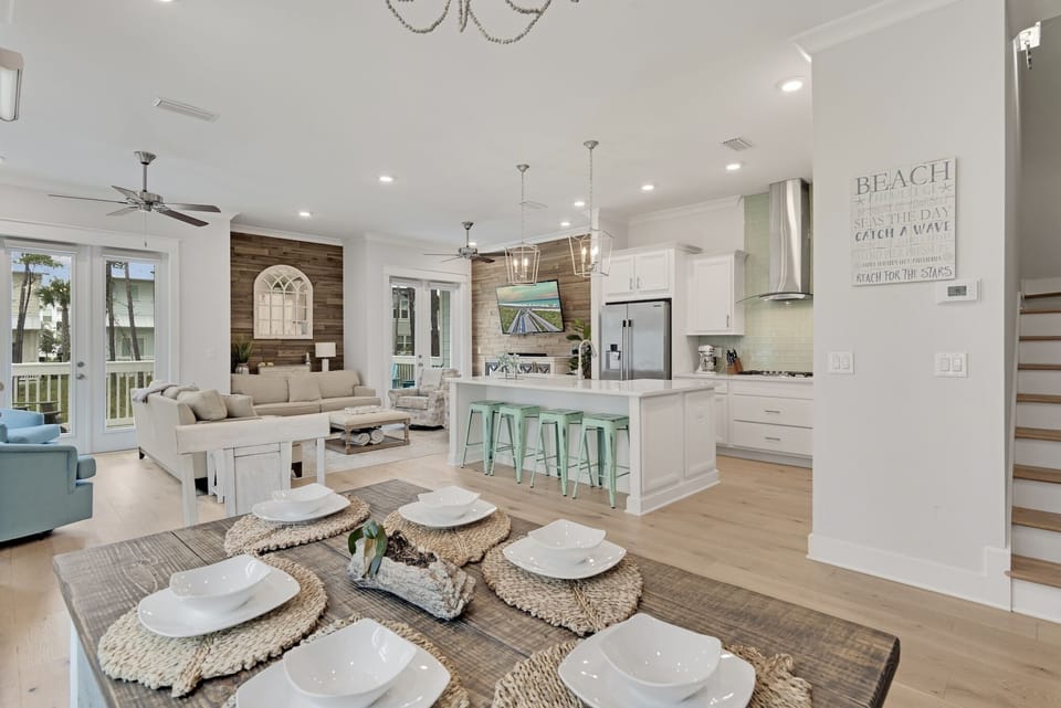 Open-concept space where the kitchen flows into a living room with comfortable seating, allowing for simultaneous cooking, dining, and relaxation.