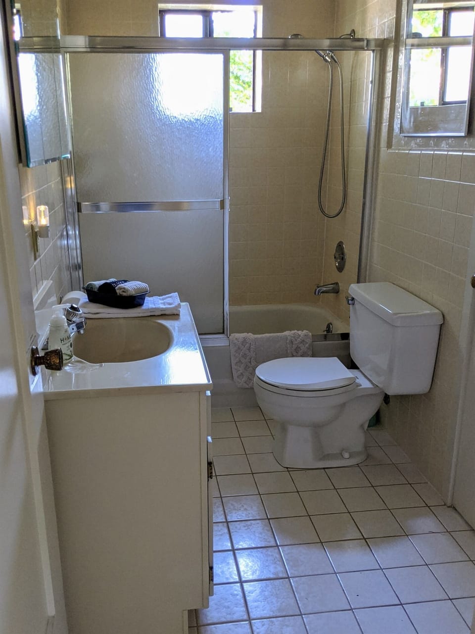Downstairs bathroom has a bath/shower combo with handheld shower nozzle.