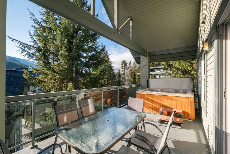 Private deck: Hot tub, outdoor dining, mountain and forest views