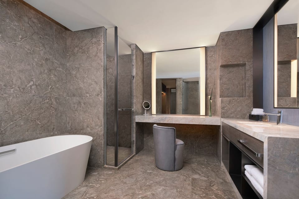 Club Suite, 1 Bedroom, River View | Bathroom | Separate tub and shower, rainfall showerhead, designer toiletries