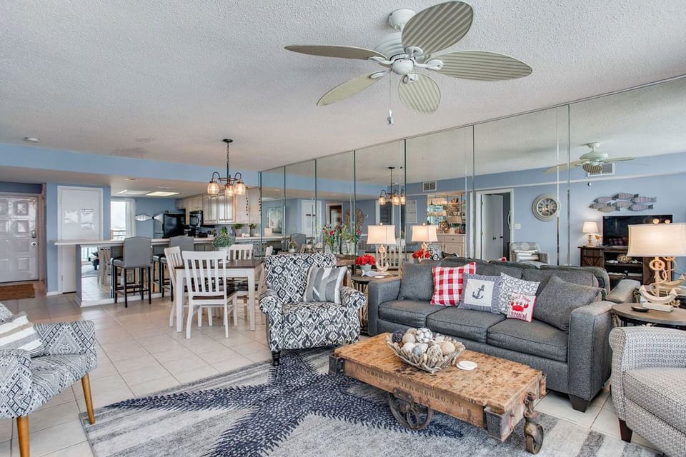 Living area with queen sofa sleeper and Gulf-view balcony access at Wind Drift