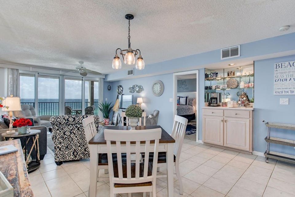 Open living and dining with floor-to-ceiling Gulf views at Wind Drift Orange Beach