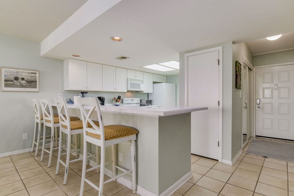 Kitchen with breakfast bar seating at Wind Drift Orange Beach Gulf-front condo