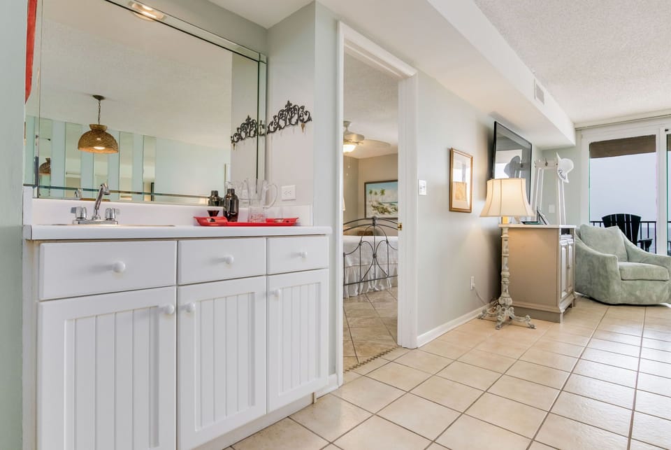 Open kitchen with white cabinets at Wind Drift Orange Beach vacation rental