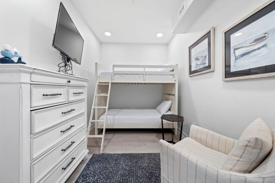 Your cozy bedroom features a space-saving bunk bed and comfortable seating area, perfect for relaxing after your adventures.