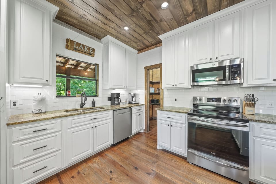Step into a chef-inspired kitchen where rustic design meets modern convenience — complete with oven, gas range, and granite countertops.