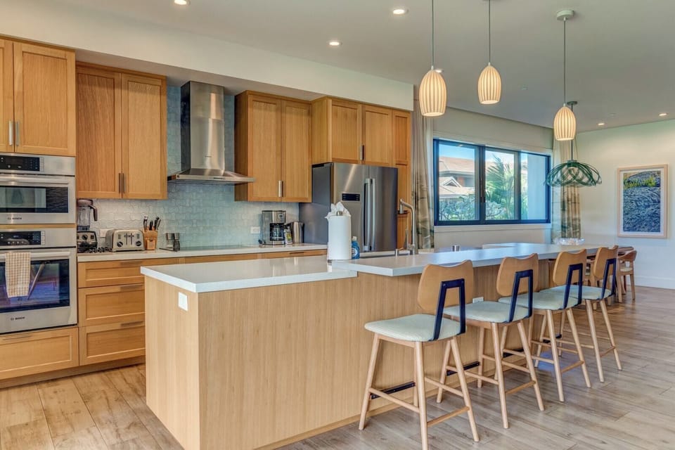 Sleek modern kitchen with island seating and ample natural light