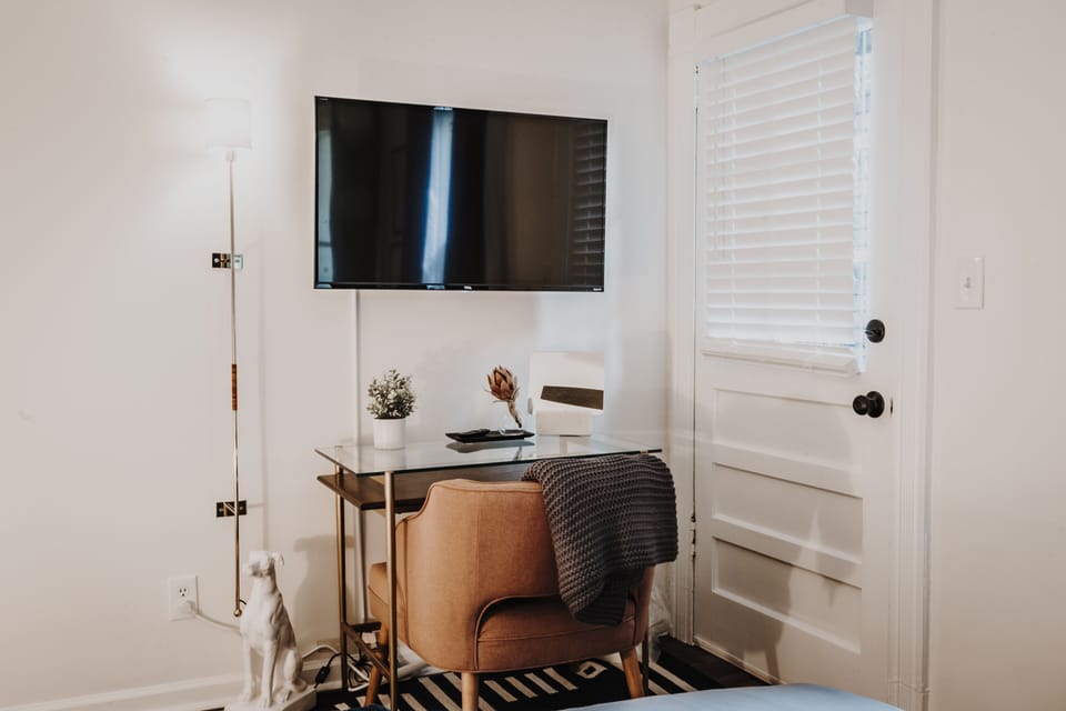 Room Three is a private bedroom with queen bed, smart TV, and desk.