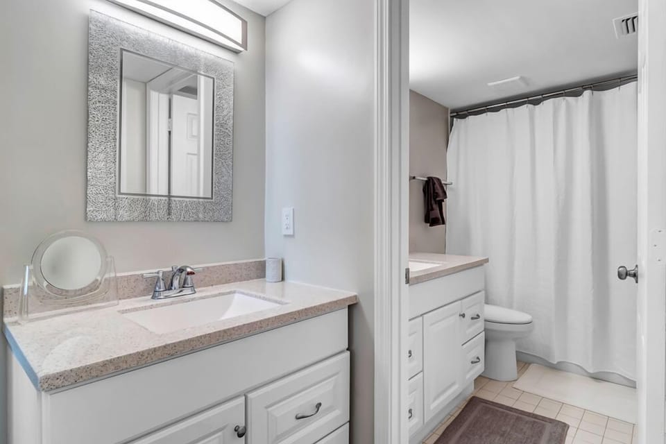 - Clean, modern bathroom with dual sink vanity, large mirror, and tub-shower combo
- Plenty of counter space and storage drawers for all your essentials
- Neutral tones and soft lighting make this a comfortable daily retreat