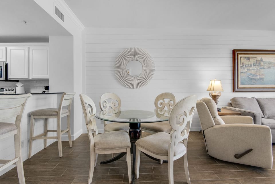Dining Area - Gather in this stylish dining area with seating for four, perfect for savoring home-cooked meals while soaking in stunning beach views.