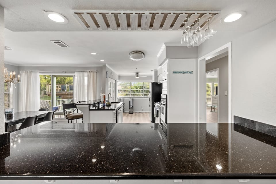 Open-plan kitchen and dining at Lakeview Landing — the granite island anchors the space where your group gathers morning to night.