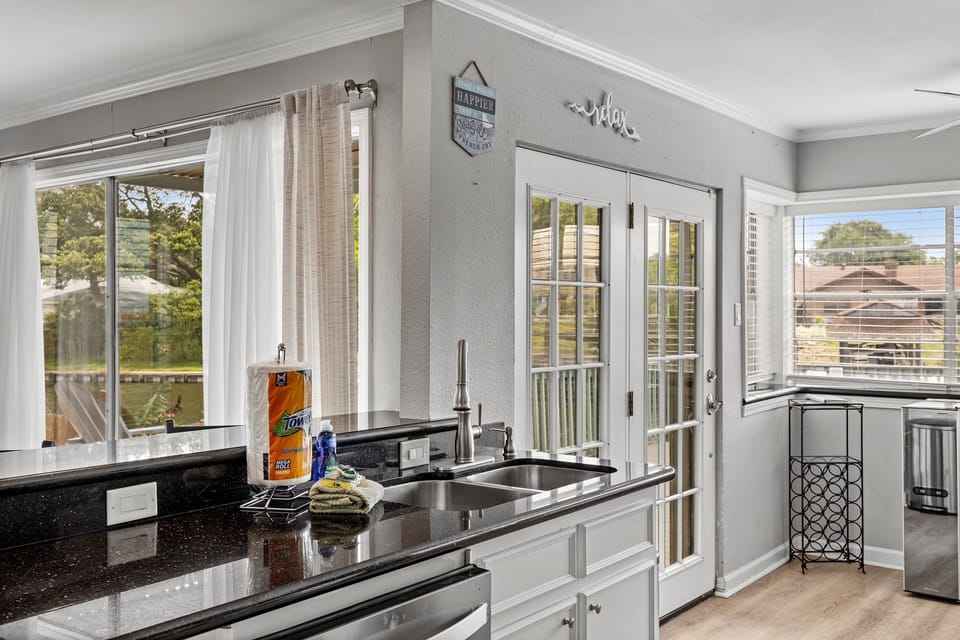 Coastal kitchen at Lakeview Landing — natural yard views and beach-inspired details make every meal feel like a true Galveston getaway.
