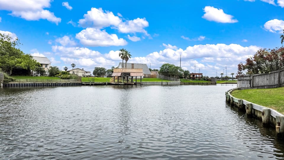 Madeline Lake from Lakeview Landing's dock — calm open water perfect for kayaking, paddleboarding, or simply soaking in the Galveston sunshine.