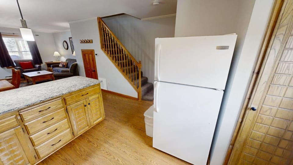 Bright open-concept space connects your kitchen, dining, and living areas, with natural light flowing through and wood accents adding warmth. Your full kitchen ensures easy meal prep during your stay.