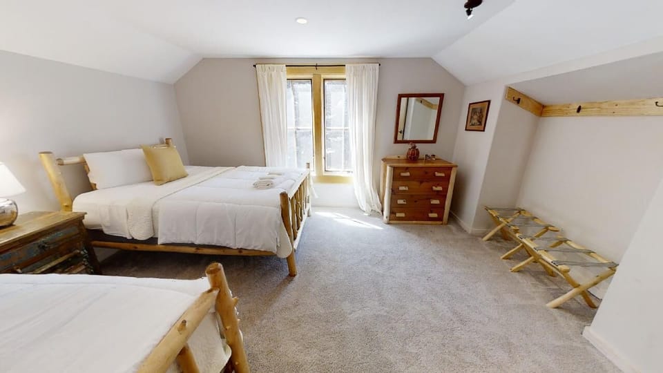 Sink into soft linens and wake to natural light streaming through your window. This spacious room offers plush beds and cozy charm for restful nights.