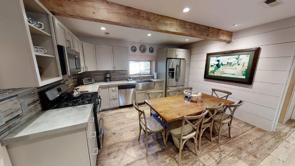 Cook your favorite meals in this beautifully designed kitchen featuring stainless appliances and gather around the rustic dining table for memorable meals together.