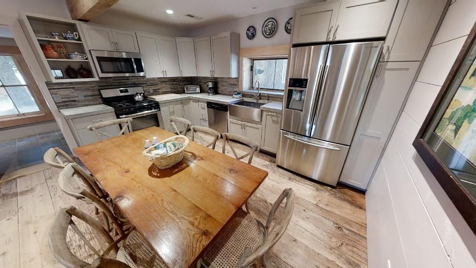 Gather around the charming farmhouse table in your fully equipped kitchen, where cooking feels like home with stainless steel appliances, custom cabinetry, and plenty of space to create lasting memories.