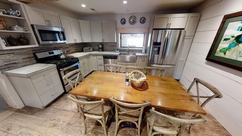 Gather around this stunning live-edge table in your fully equipped kitchen, perfect for preparing meals together and savoring morning coffee while planning the day's adventures.