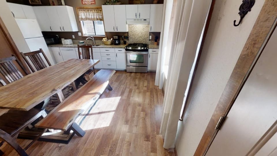 Step into your fully-equipped kitchen where you can whip up your favorite meals. The open layout and natural light make cooking a joy as you prepare breakfast at the spacious dining table.