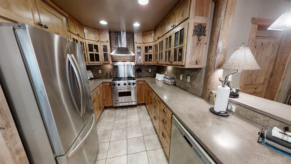 Step into your fully-equipped kitchen, where rustic charm meets modern convenience. Gleaming stainless appliances, ample counter space, and warm wood cabinetry invite you to cook, gather, and create memories.