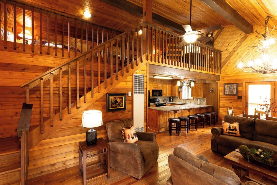 Step into your cozy cabin retreat, where soaring wood-beam ceilings and rustic elegance greet you. Relax by the warmth of home, unwind in plush seating, and enjoy your fully-equipped kitchen—all yours to enjoy.