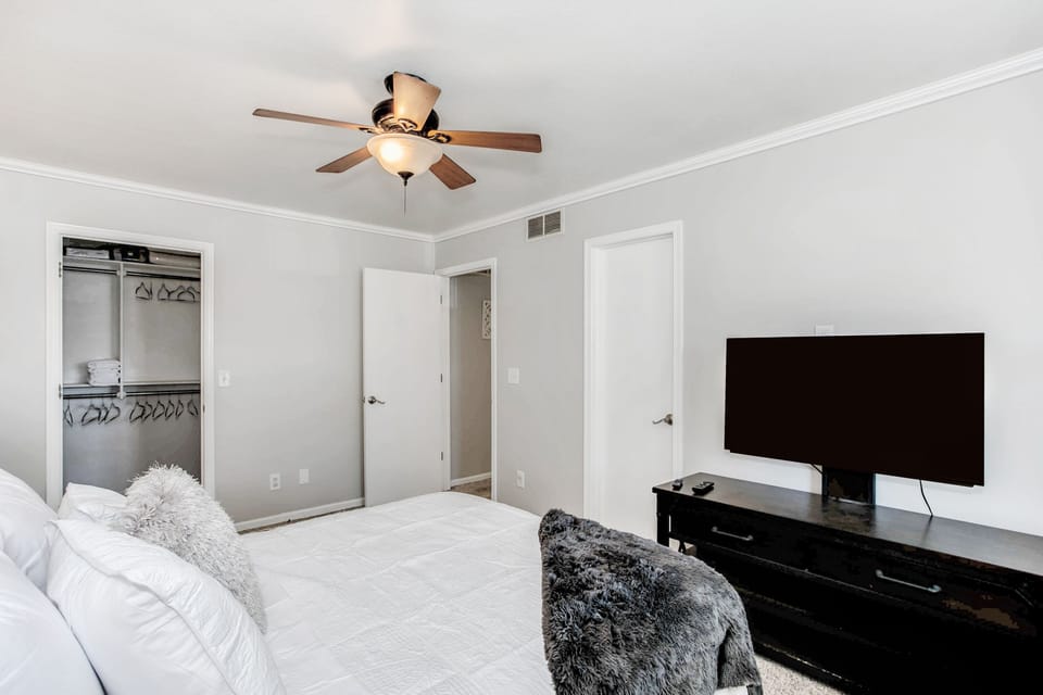 Master bedroom with smart tv and walk in closet 